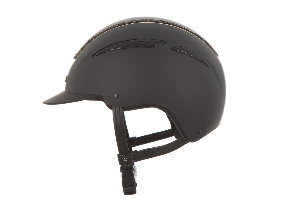 A matte black equestrian riding helmet with a visor and adjustable chin strap, shown from a side profile view against a solid white background.