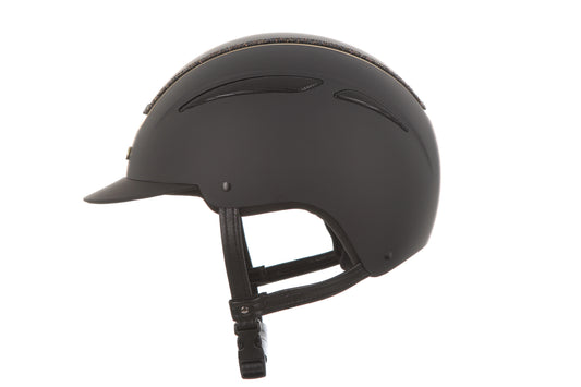 A matte black equestrian riding helmet with a visor and adjustable chin strap, shown from a side profile view against a solid white background.